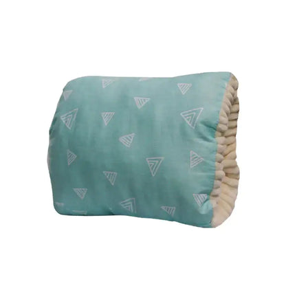 Teal cushion with triangle pattern on a white background