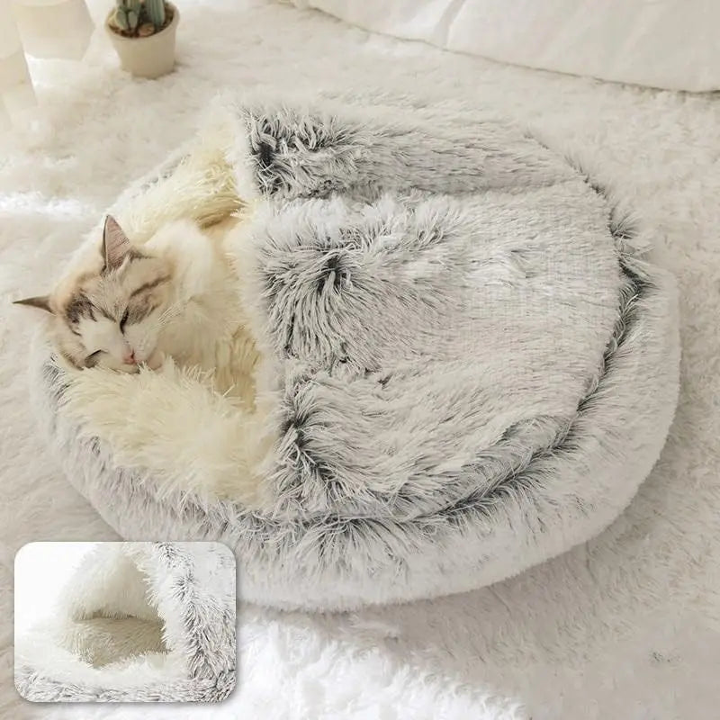 Fluffy pet bed with a cat inside on a soft surface
