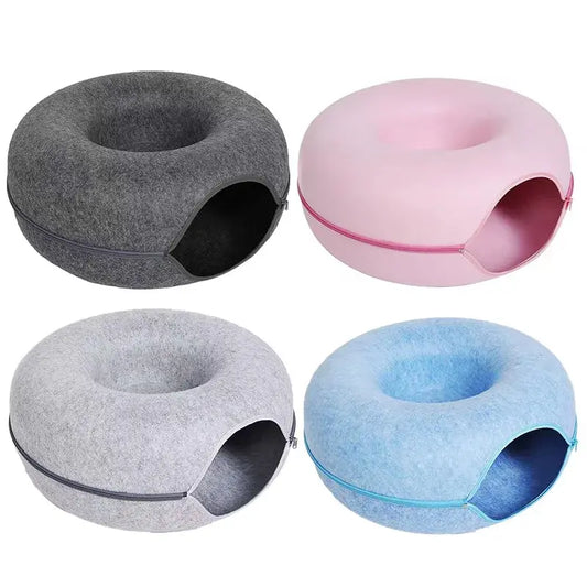 Four pet houses in gray, pink, blue, and light gray on a white background