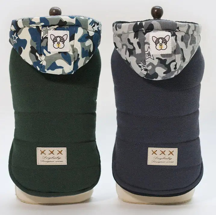 Two dog coats with camouflage hoods on a white background
