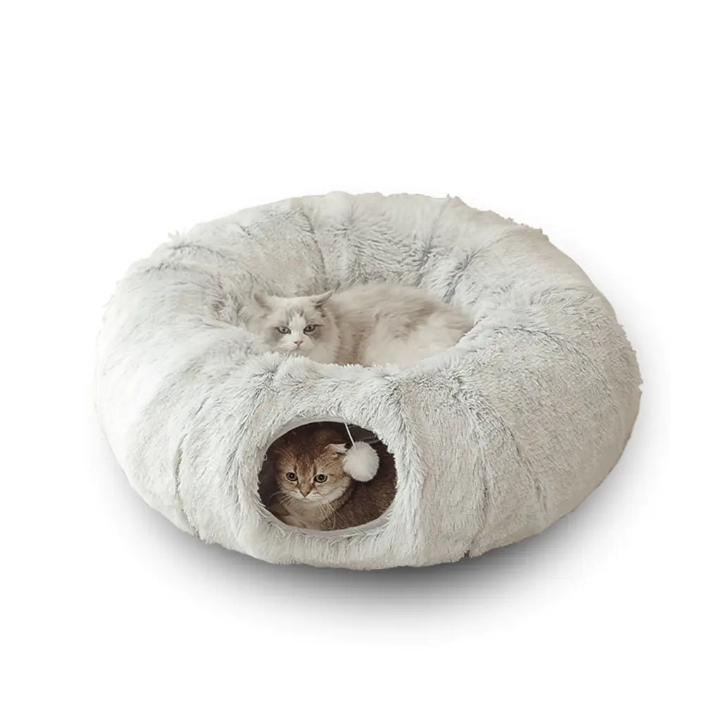 Fluffy donut-shaped pet bed with two cats inside on a white background