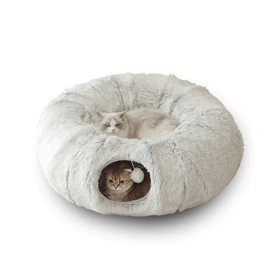 Fluffy donut-shaped pet bed with two cats inside on a white background