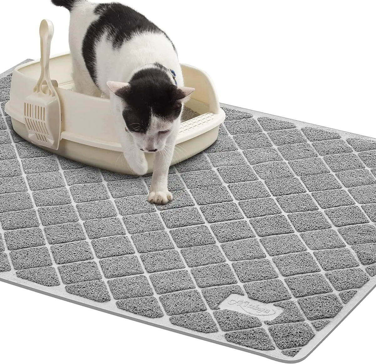 Cat using a litter box on a gray mat with a white background